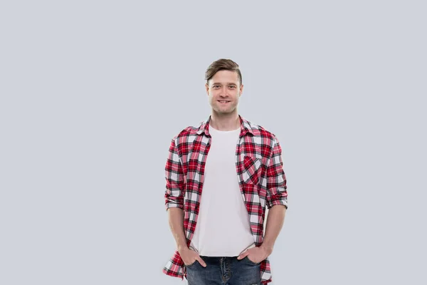 Příležitostné muž šťastný úsměv mladý pohledný chlap ruce v kapse nosí kostkované košili, samostatný — Stock fotografie