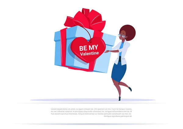 Mujer afroamericana sosteniendo gran caja de regalo con etiqueta de forma de corazón Be Me Valentine Saludo sobre fondo de plantilla — Archivo Imágenes Vectoriales