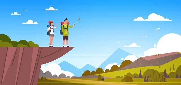 Pareja de turistas con mochilas tomando selfie sobre hermosa naturaleza paisaje fondo hombre y mujer senderismo — Vector de stock