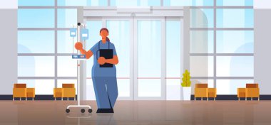 üniforma tutan damlalık tıp sağlık kavramı modern hastane tıp kliniği salonu iç tam uzunlukta yatay düz kadın doktor anesteziuzmanı