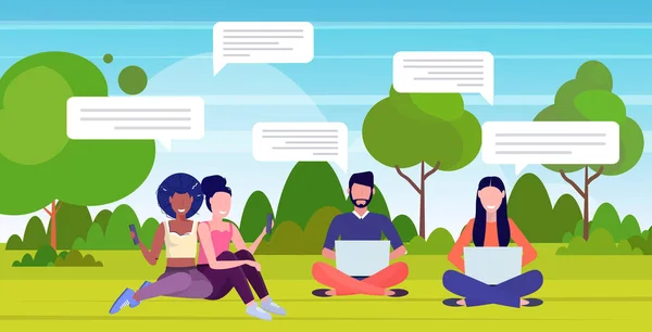 Lidé pomocí chatování aplikace na digitálních zařízeních sociální síť chat bublina komunikace koncept mix závod muži ženy sedí na zelené trávě v parku horizontální plné délky — Stockový vektor