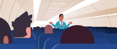 Kamarot, Afro-Amerikan uçuş görevlileri için talimatlar açıklıyordu. Üniformalı, acil durum çıkışları, güvenlik göstergesi, uçak konsepti, iç yatay...