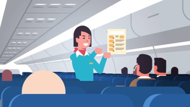 Hostes yolculara talimat veriyor. Kadın uçuş görevlisi güvenlik tanıtımı. Modern uçak panosu iç yatay portresi.