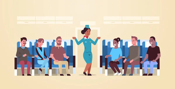 Αεροσυνοδός εξηγεί τις οδηγίες για το μίγμα των επιβατών αγώνα αφροαμερικανός αεροσυνοδός με στολή δείχνει εξόδους κινδύνου ασφαλείας έννοια αεροπλάνο πίνακα εσωτερικό οριζόντια — Διανυσματικό Αρχείο