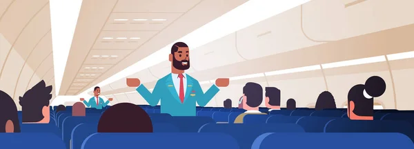 Steward erklärt Anweisungen für Passagiere afrikanisch-amerikanische männliche Flugbegleiter in Uniform zeigen Notausgänge Sicherheitsvorführkonzept Flugzeug Innenraum horizontal — Stockvektor