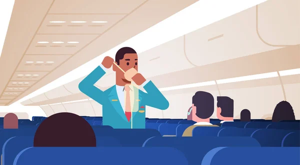 Stevard vysvětluje cestujícím, jak používat kyslíkovou masku v nouzové situaci afroameričtí muži let letuška bezpečnostní demonstrace koncept moderní palubní letadlo horizontální — Stockový vektor