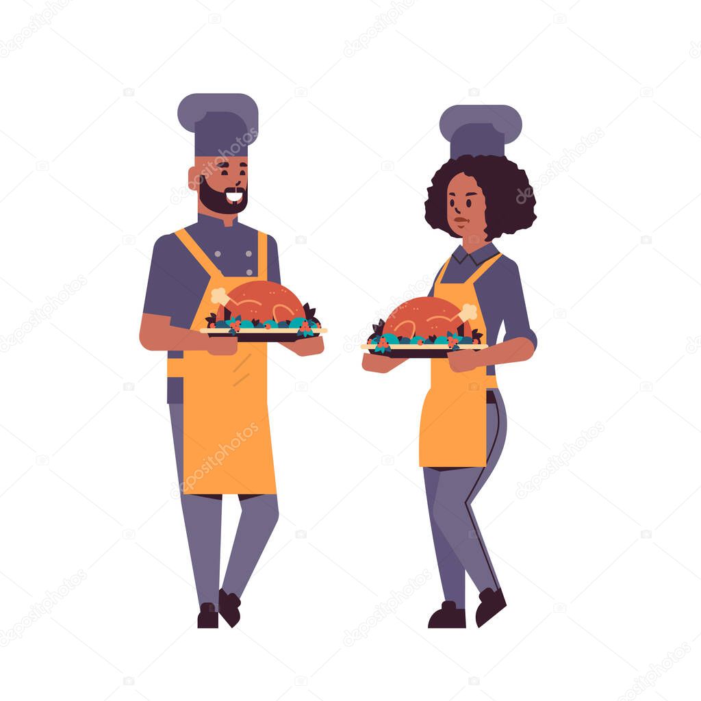 cooks couple professional chefs holding trays with roasted chicken man woman restaurant workers in uniform carrying platters with thanksgiving turkey cooking food concept flat full length