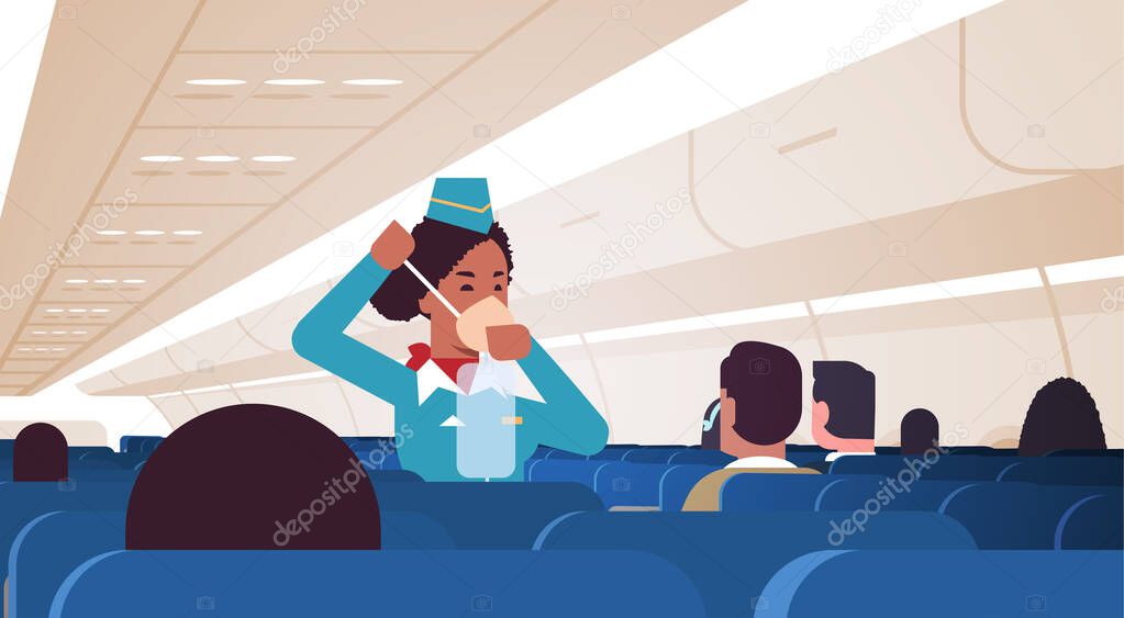 stewardess explaining for passengers how to use oxygen mask in emergency situation african american flight attendant safety demonstration concept modern airplane board interior horizontal