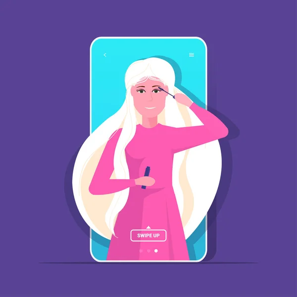 Blogger uroda stosowania tusz kobieta vlogger pokazując trend makijaż samouczek blogowanie koncepcja portret smartfon ekran aplikacja mobilna — Wektor stockowy
