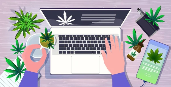 Human hands using laptop medical cannabis leaves drugs consumption marijuana products at workplace desk top angle view horizontal — Stock vektor