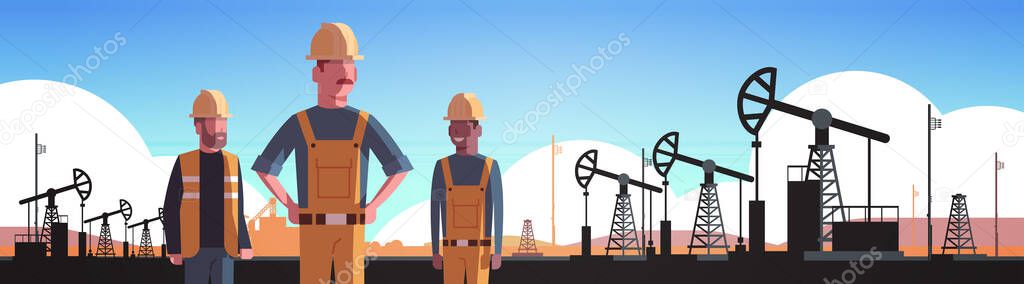workers in orange uniform working on oil drilling rig pumpjack petroleum production trade oil industry concept portrait horizontal