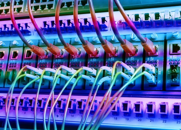 Fiber Optic cables connected to an optic ports and Network cables connected to ethernet ports