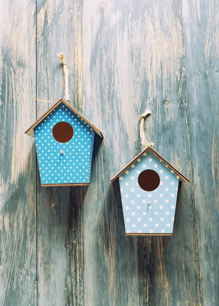 Dwa domki dla ptaków na zabytkowym tle z drewna rustykalnego. — Zdjęcie stockowe