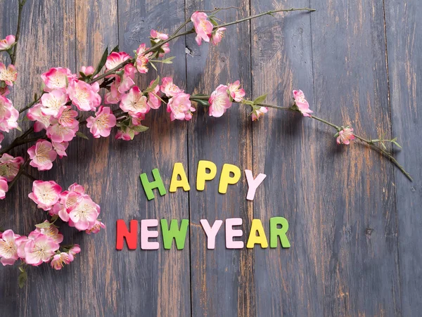 Letter HAPPY NEW YEAR on wood texture background — Stock Photo, Image