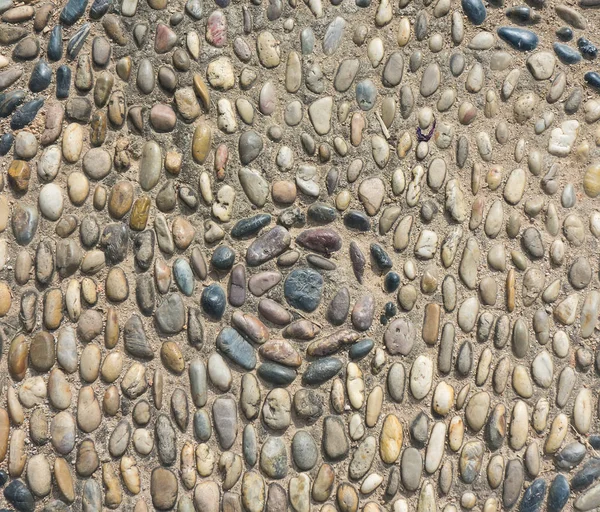 Hintergrund aus einer Nahaufnahme einer Mauer mit Kieseln — Stockfoto