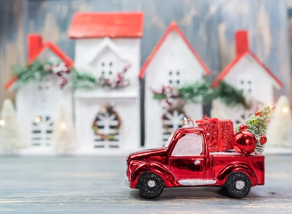 Christmas ornaments and car toy with tree presents on wooden hou — Stock Photo, Image