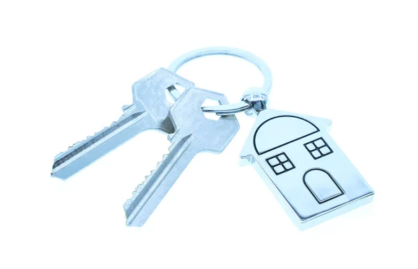 Přívěšek na klíče se symbolem domu a klávesami na bílém pozadí, Real es — Stock fotografie