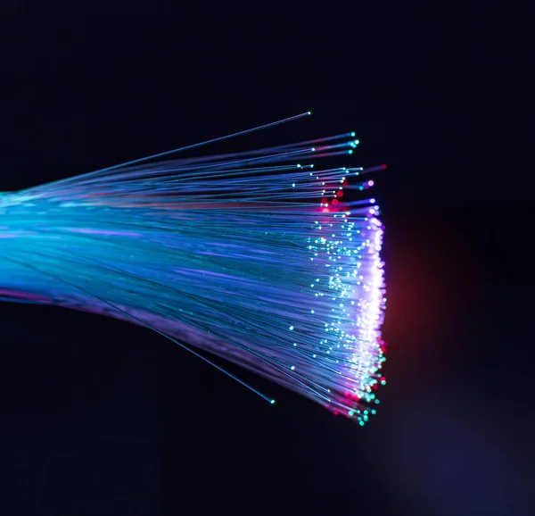 Optical fibres dinamic flying from deep on technology background — Stock Photo, Image