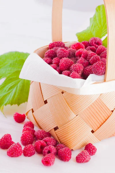 Raspberries in a small basket — Stock Photo, Image