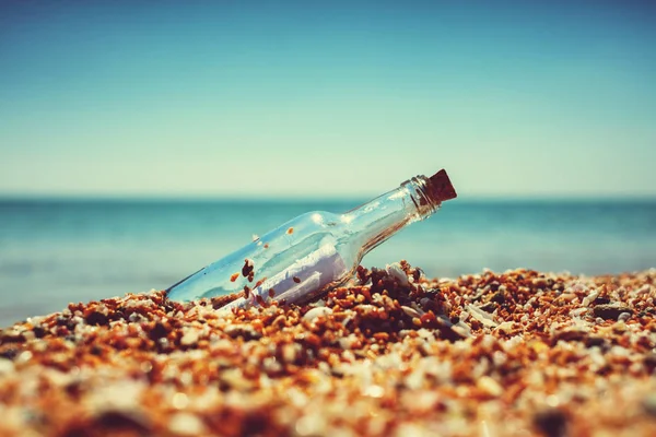 Message in bottle on sea shore — Stock Photo, Image