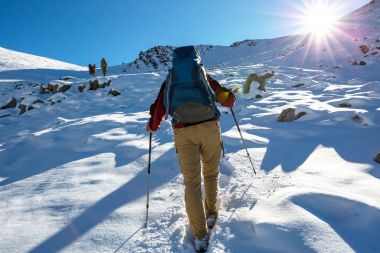 Kış dağlarında yürüyüşçüler