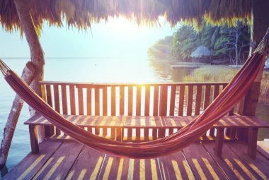 Hammock on the lake at sunset clipart