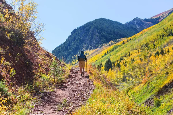 Hike in the autumn mountains. Fall season theme.