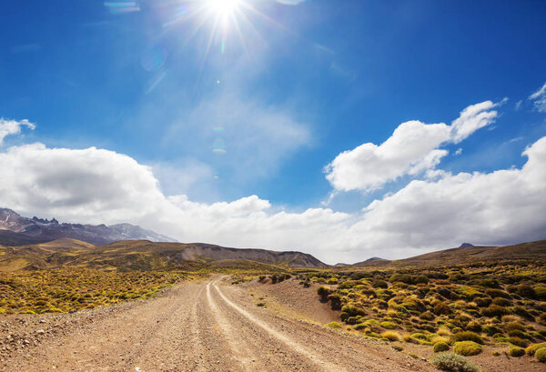 Road in the prairie country. Deserted natural travel background.