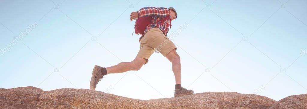 Hiker in unusual stone formations in Alabama hills, California, USA