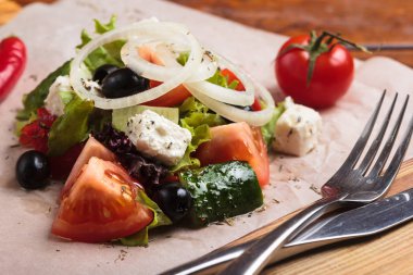 Yunan salatası malzemeler ile kağıt üzerinde hizmet