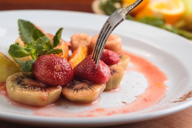 Meyve beyaz tabakta flambe.