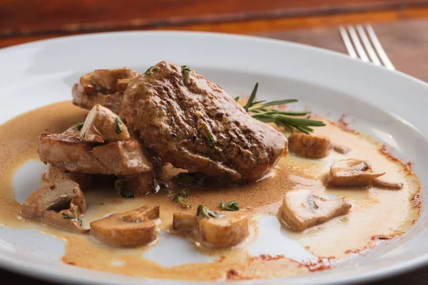 Médaillons de porc avec sauce aux champignons Image En Vente