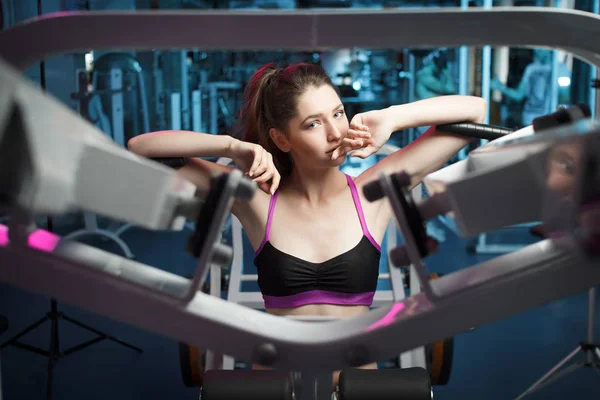 Beautiful attractive feminine sensual girl take breath during fitness workout at the gym.