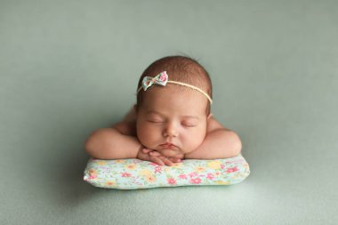 Little beautiful baby sleeps on a pillow.
