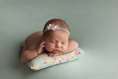  Little beautiful baby sleeps on a pillow.