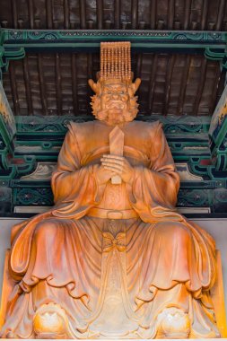 Wooden sculptured Buddhist Diety clipart