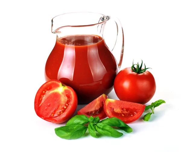 Jug, glass of tomato juice and fruits with green leaves — Stock Photo, Image