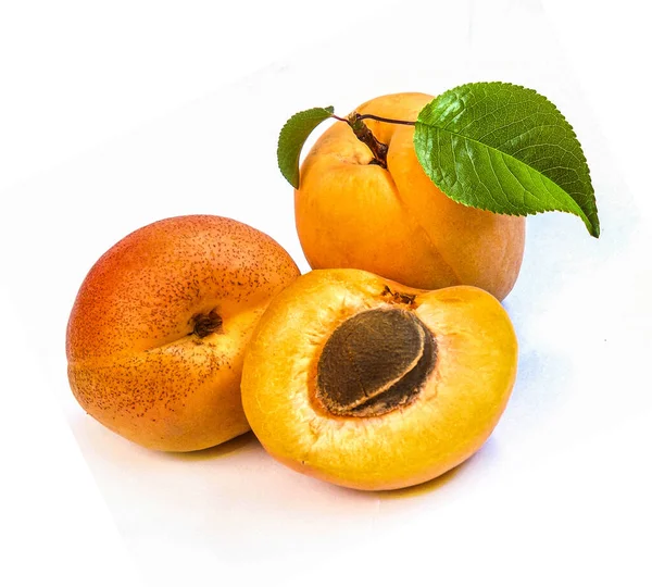 Aprikosenfrüchte Und Die Hälfte Mit Blatt Isoliert Auf Weißem Hintergrund — Stockfoto