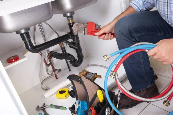 Plumber on the kitchen. — Stock Photo, Image