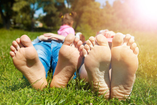 Family lying on the grass in the morning