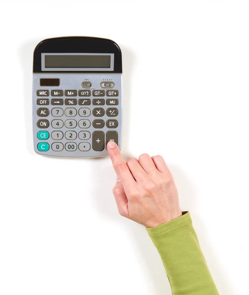 Mão em casaco verde e calculadora cinza — Fotografia de Stock