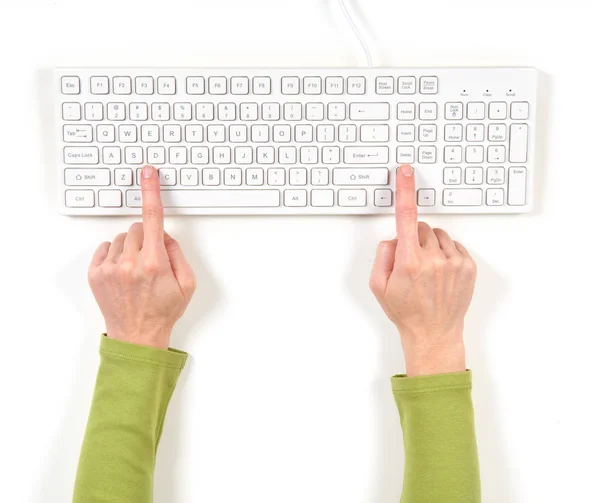 Hands in green jacket and white keyboard — Stock Photo, Image