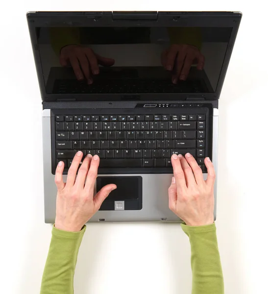 Hands in green jacket and black laptop — Stock Photo, Image