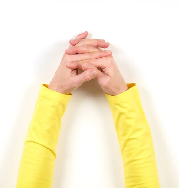 Handen in gele jas en gebaren — Stockfoto