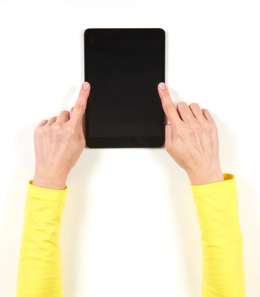 Hands in yellow jacket and black tablet — Stock Photo, Image