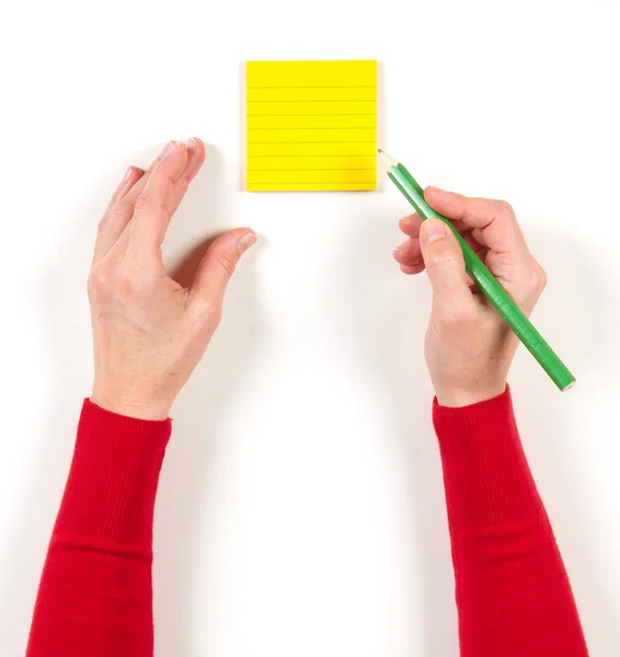 Hand en geel papier op tafel — Stockfoto