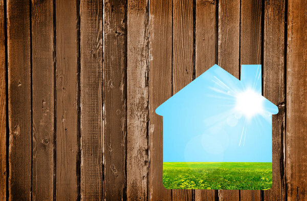 Small house on a wooden wall