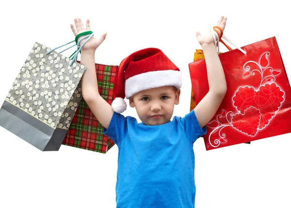 Niño en gorra de piel con bolsas de compras. Navidad — Foto de Stock