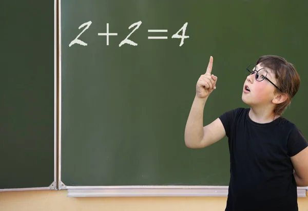 Little girl and green blackboard — Stock Photo, Image