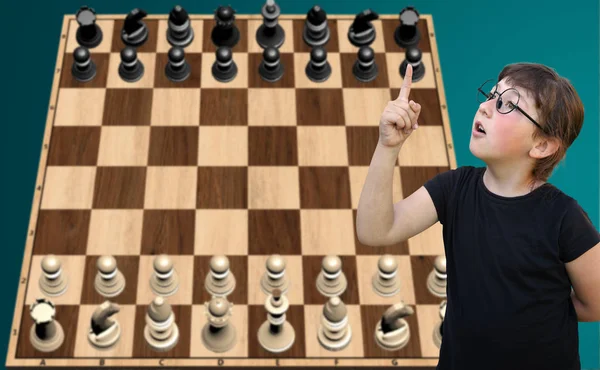 Девочка в очках играет в шахматы — стоковое фото